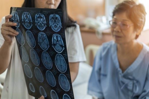 woman looking at an MRI of her brain